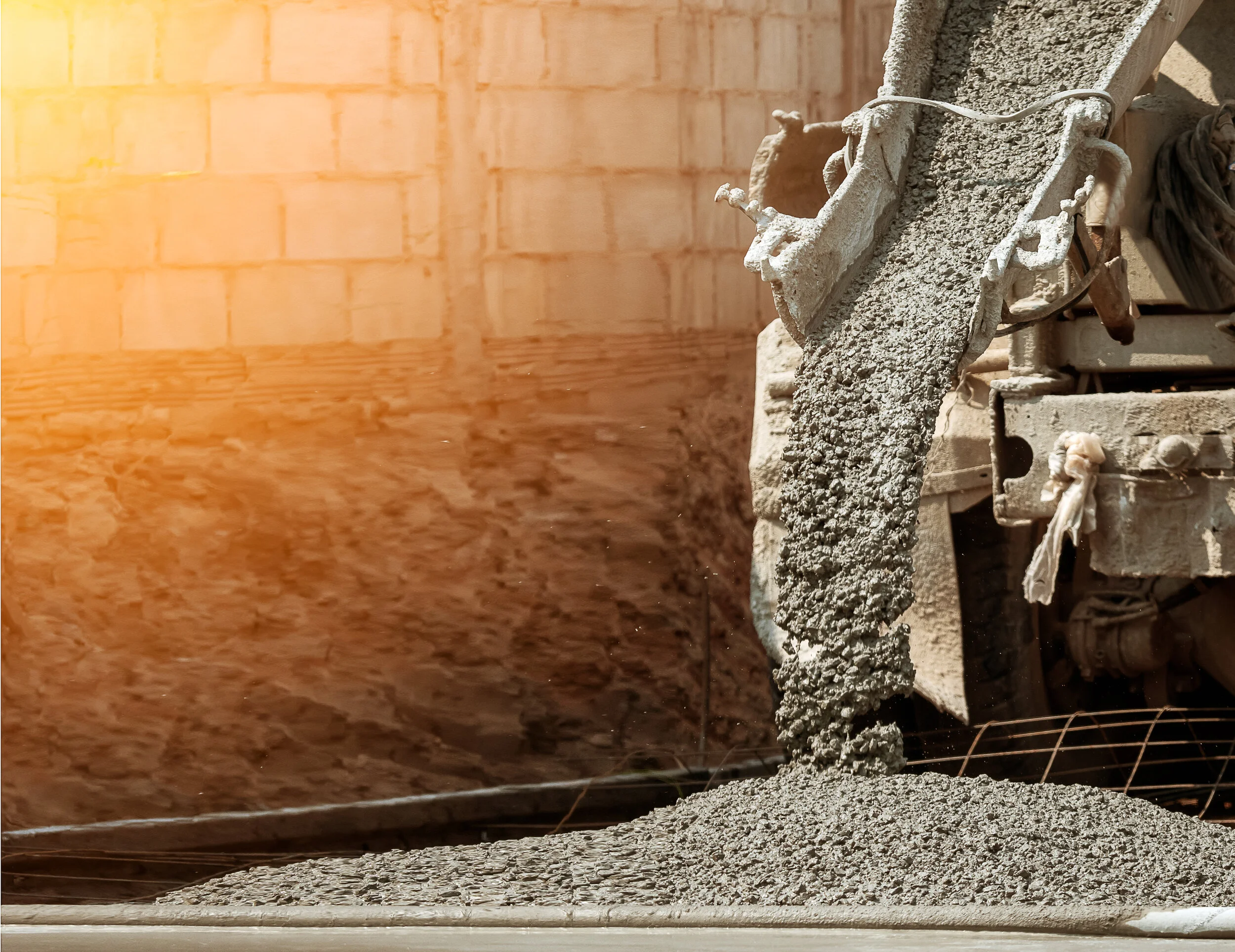 Short Load Concrete mixer truck pouring fresh ready-mix concrete on site